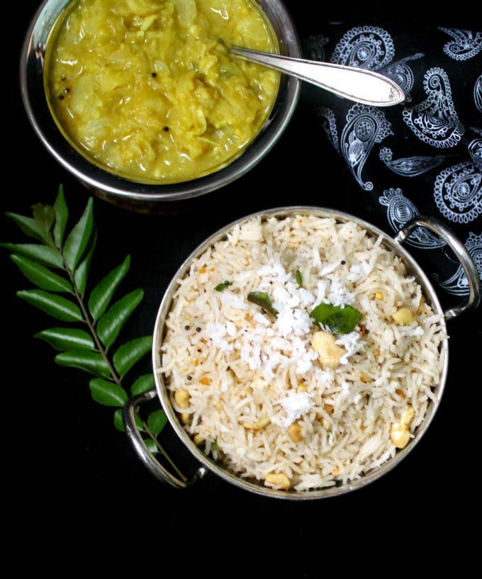 South Indian Coconut Rice in a bowl with cashew nuts and curry leaves.