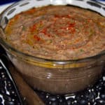 Black bean hummus with paprika and olive oil in a glass bowl