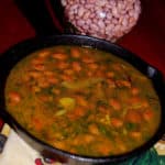 Curried Pink Beans in a skillet with more dry beans in the background
