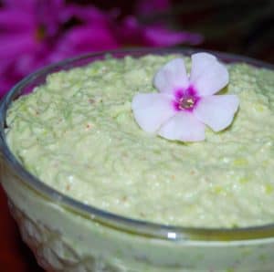 Edamame Hummus in a bowl with a pink flower