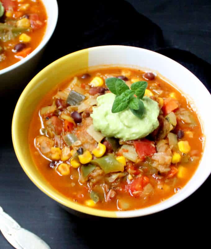 A bowl of my hearty Vegan Chili is comfort food for the soul and the tummy. This easy recipe has a mix of veggies and beans and it's smoky and rich with cumin, fire-roasted tomatoes and smoked paprika for the maximum flavor in the least amount of time. #vegan #budgetfriendly #recipe #glutenfree #soyfree #chili #dinner HolyCowVegan.net