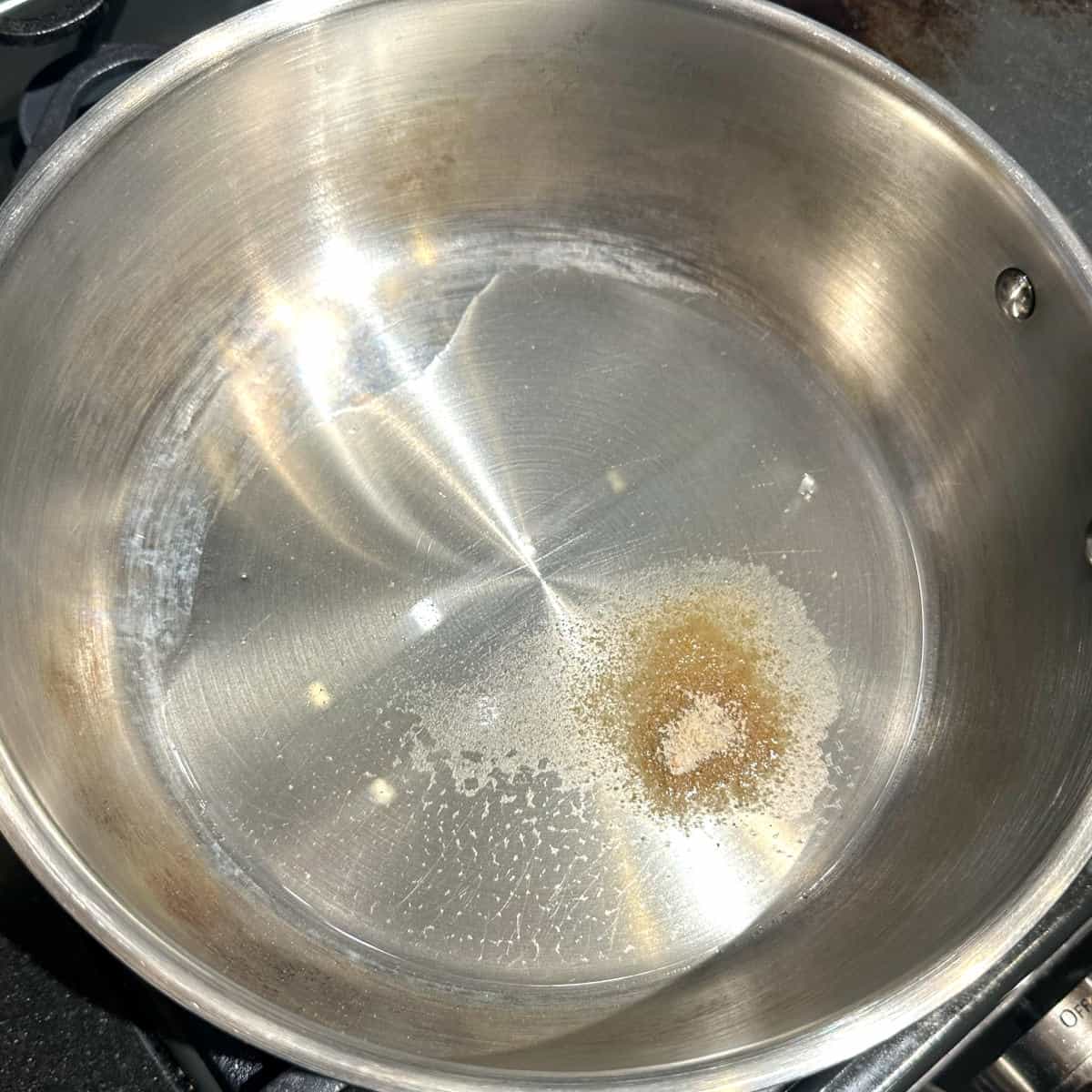 Asafetida in oil in pan.