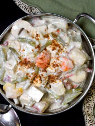 A close up top shot of a bowl of tasty navratan korma, vegan and made with cashew cream