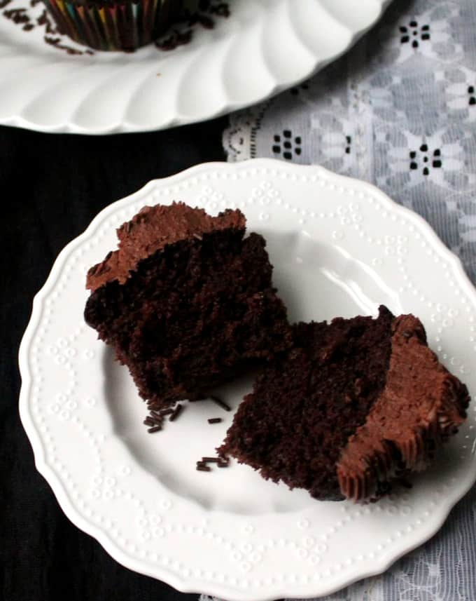 Cross section of a vegan chocolate cupcake on a white plate