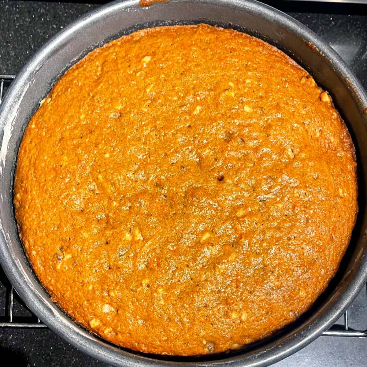 Baked vegan carrot cake in cake pan.