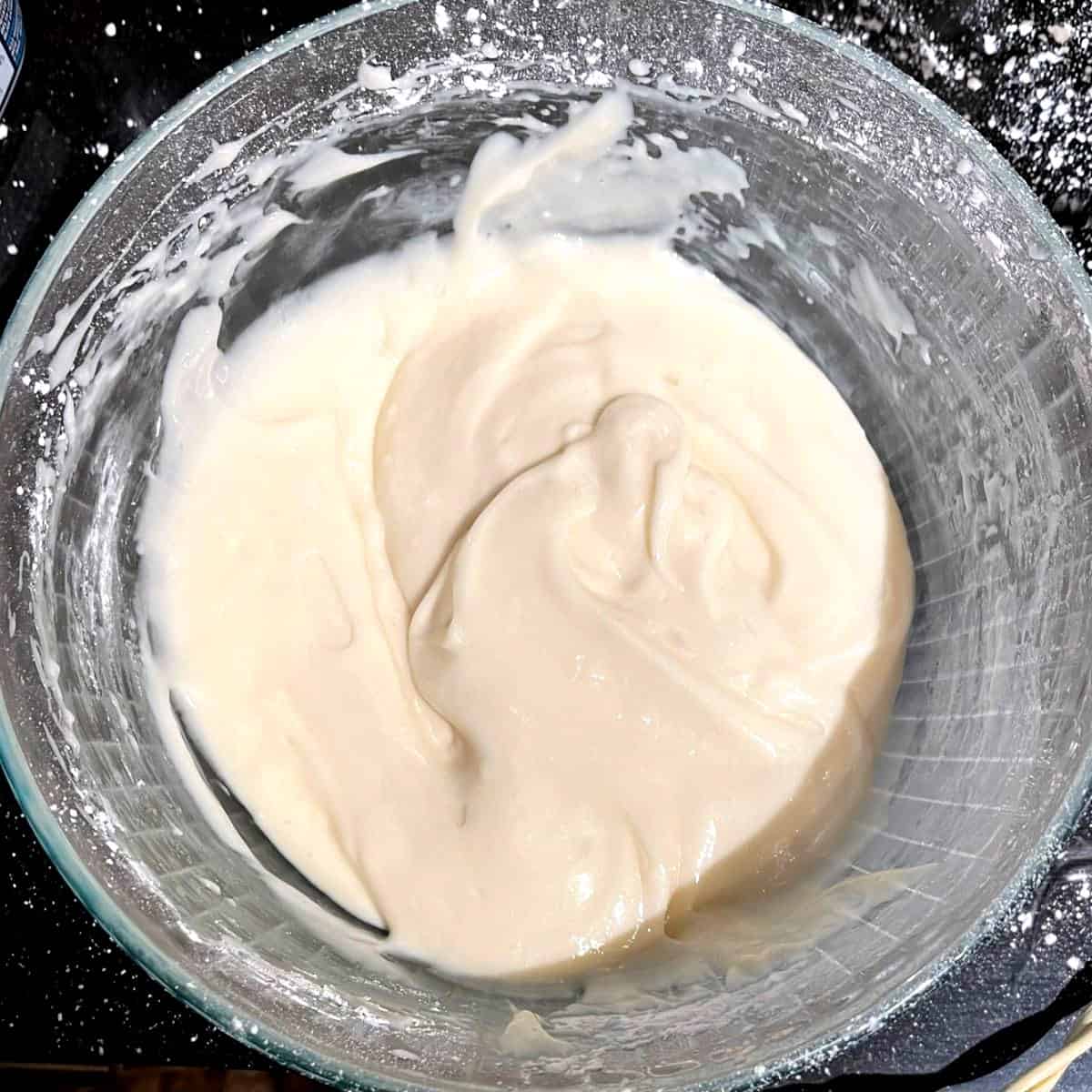Vegan cream cheese frosting in glass bowl.