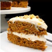 Slice of vegan carrot cake with vegan cream cheese frosting and text that says "the best vegan carrot cake".
