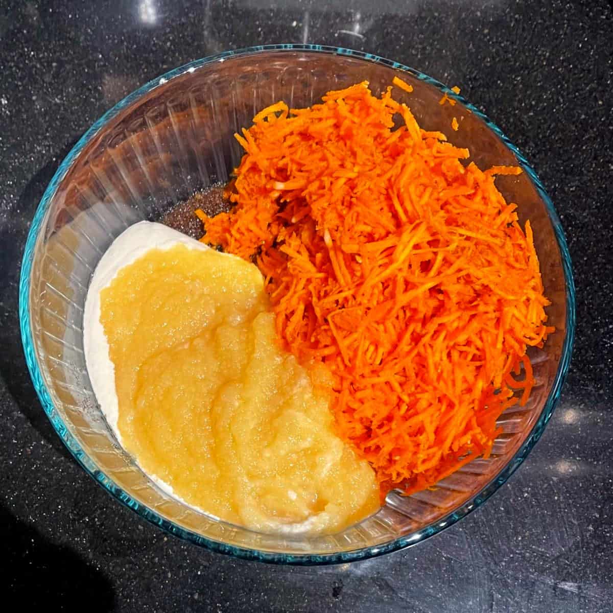 Wet ingredients for vegan carrot cake in small glass bowl.