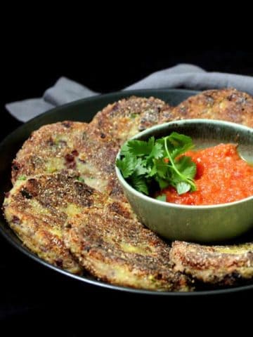 Delicious and crispy, these Mexican Potato and Bean Cakes served with a fresh tomato sauce are the perfect appetizer or snack -- but they are nutritious enough to make a great meal too! #vegan #mexican #cincodemayo #potatoes HolyCowVegan.net