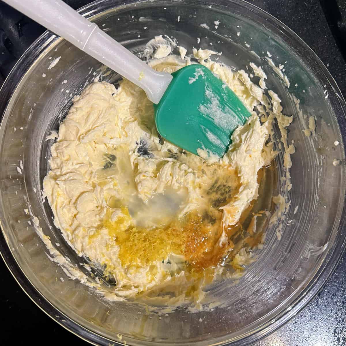Lemon juice and zest and vanilla added to bowl with butter and sugar.