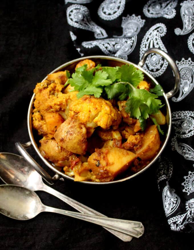 Aloo Gobi, or cauliflower and potatoes sauteed with Indian spices, is a tasty side that goes perfectly with roti, paratha, or dal and rice. #Indian #vegan #dinner #side #vegetarian #recipe HolyCowVegan.net