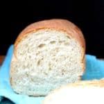 A close up shot of a cross-section of a perfectly baked sandwich bread on a blue napkin