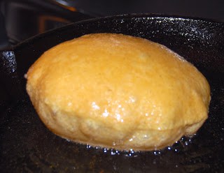 Poori puffed in frying pan.