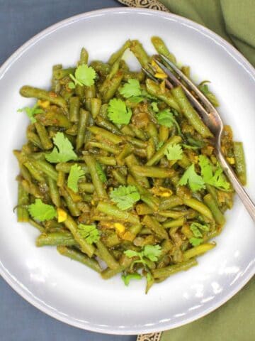 Trinidadian green beans in bowl with fork.