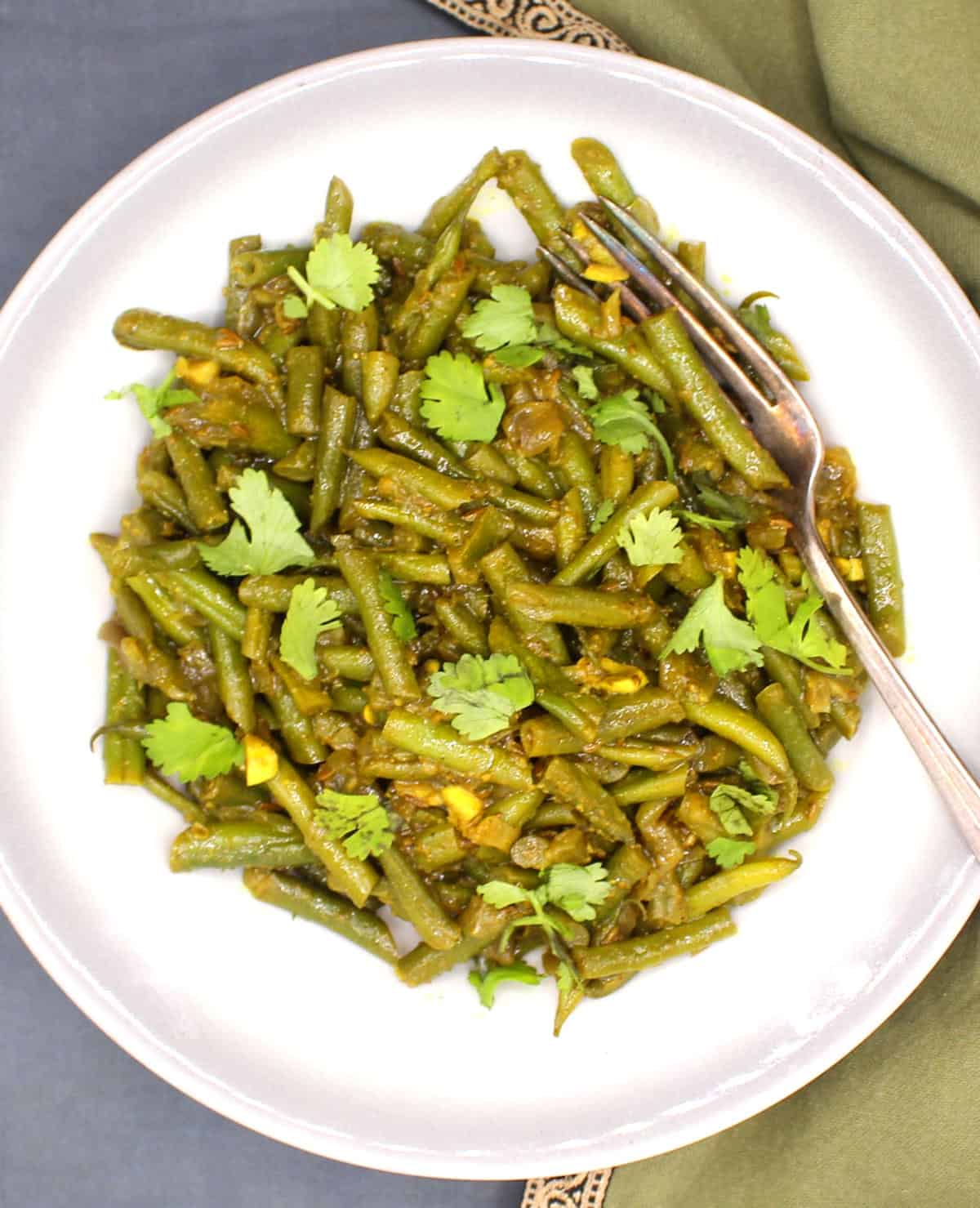 Trinidadian green beans or bodi in bowl with fork.