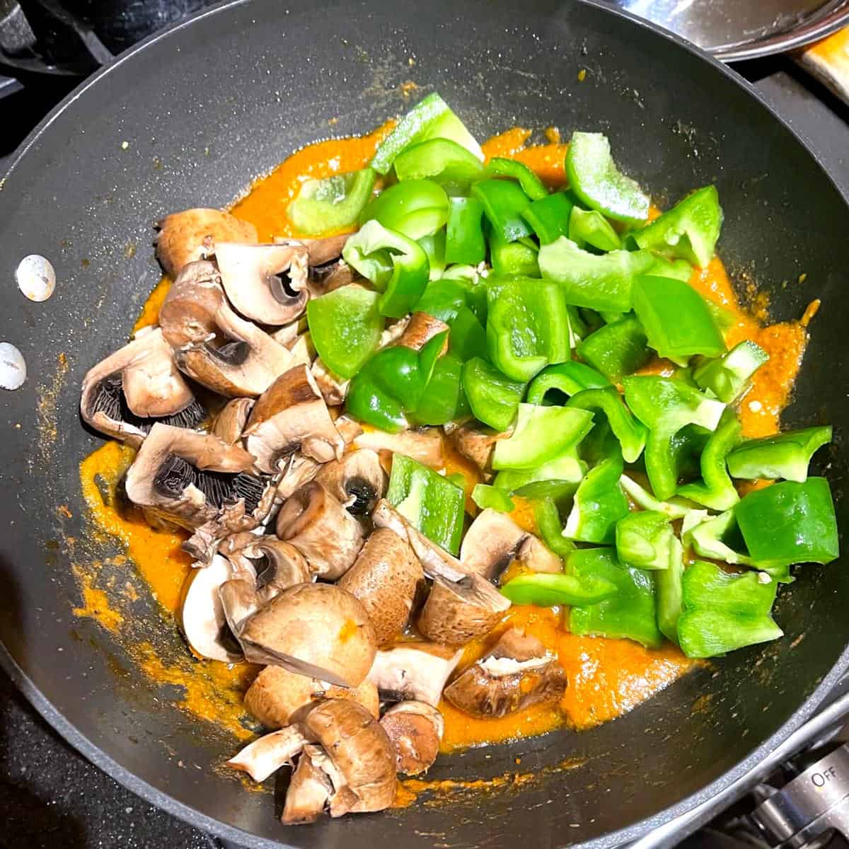 Mushrooms and bell peppers added to mushroom makhani sauce.