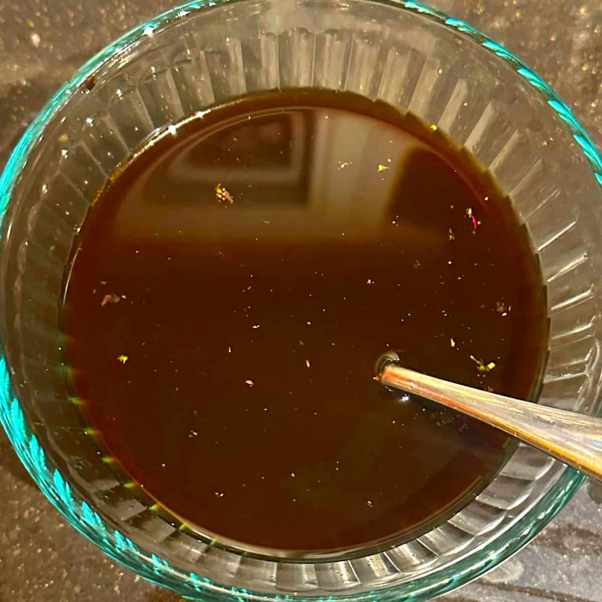 Vegetable stock mixed with soy sauce, sriracha and other sauce ingredients.