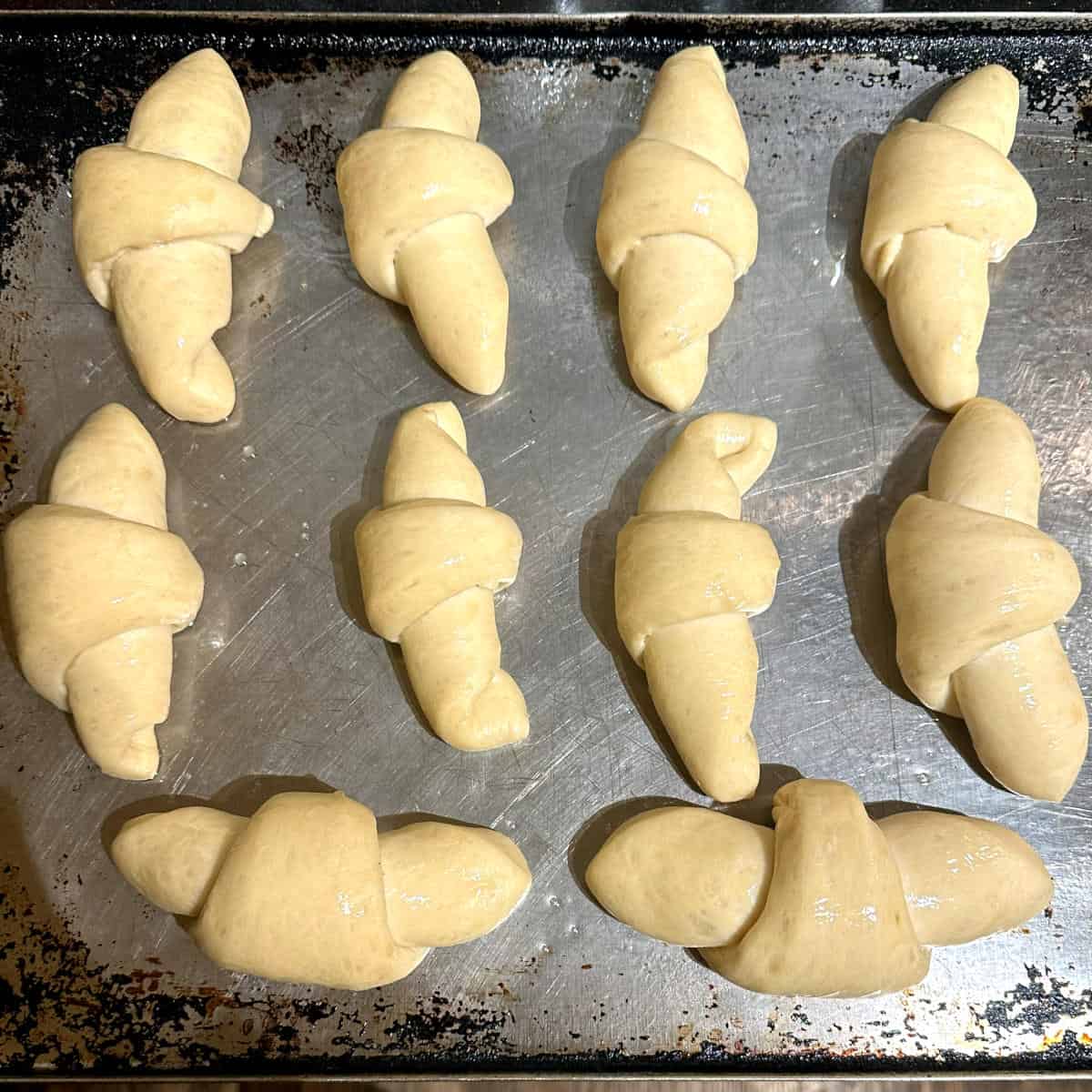 Crescent rolls on baking sheet before baking.