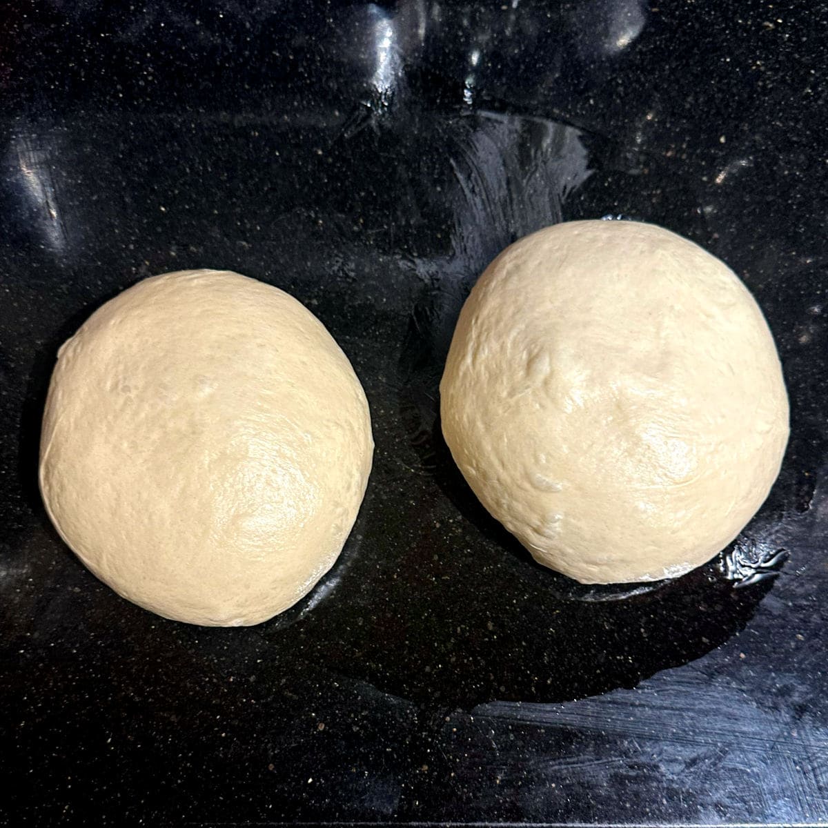 Dough for crescent rolls divided into two balls.