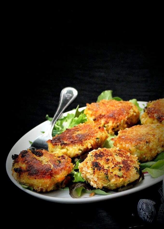 Vegetable cutlet on a plate with a fork and greens.