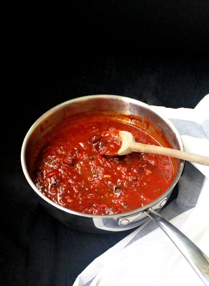 Sauce for Vegan Pasta Puttanesca in steel saucepan.