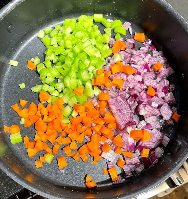 Mirepoix of onions, celery and carrots in saute pan.