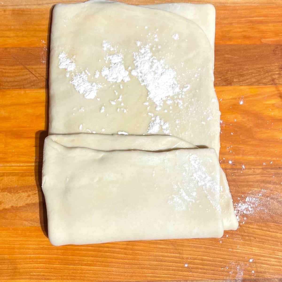 Paratha dough being folded.