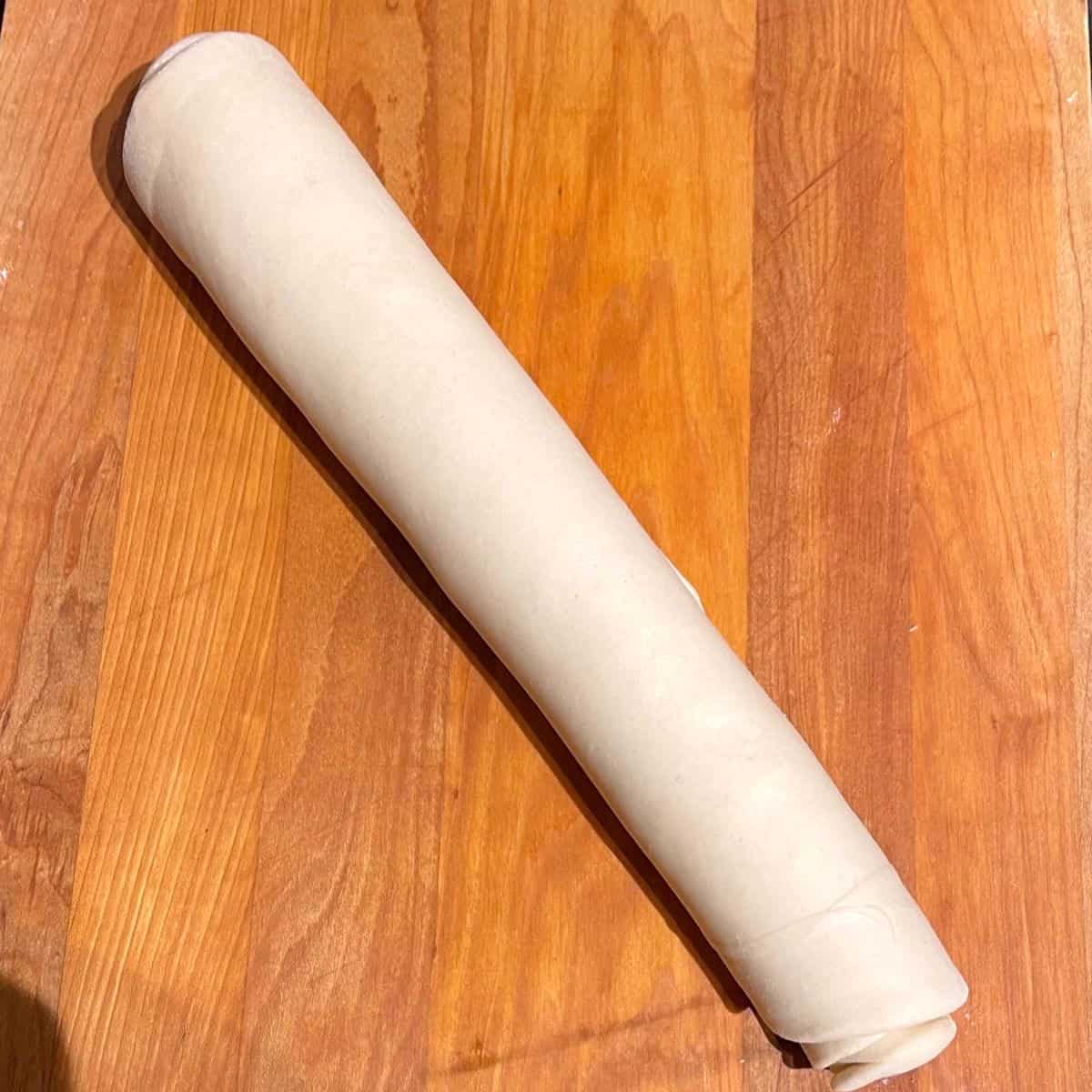 Paratha dough rolled into a cylinder.