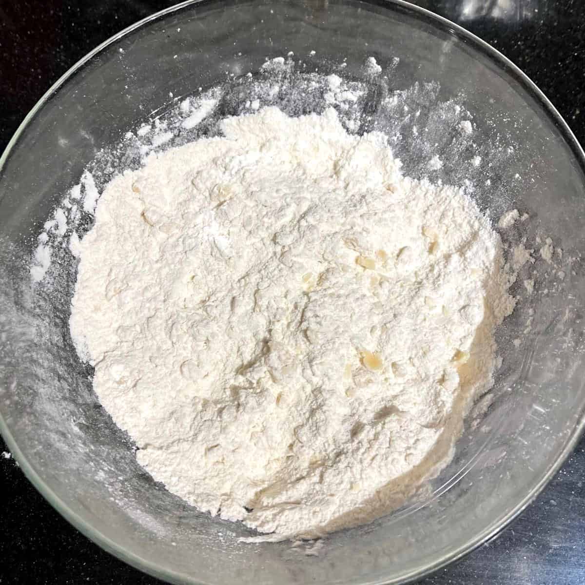 Oil mixed in flour in bowl.