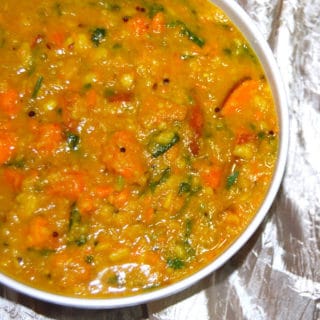 Vegan sweet potato curry with vaal dal in white bowl.