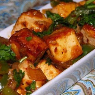 A close up shot of rich brown Chilli Tofu, Indo-Chinese style