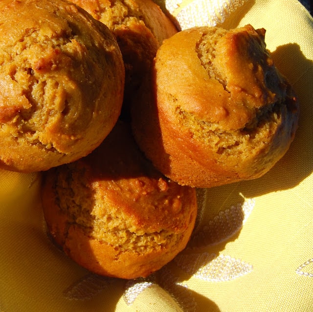 Photo of vegan butternut squash muffins nestled together on a yellow napkin.