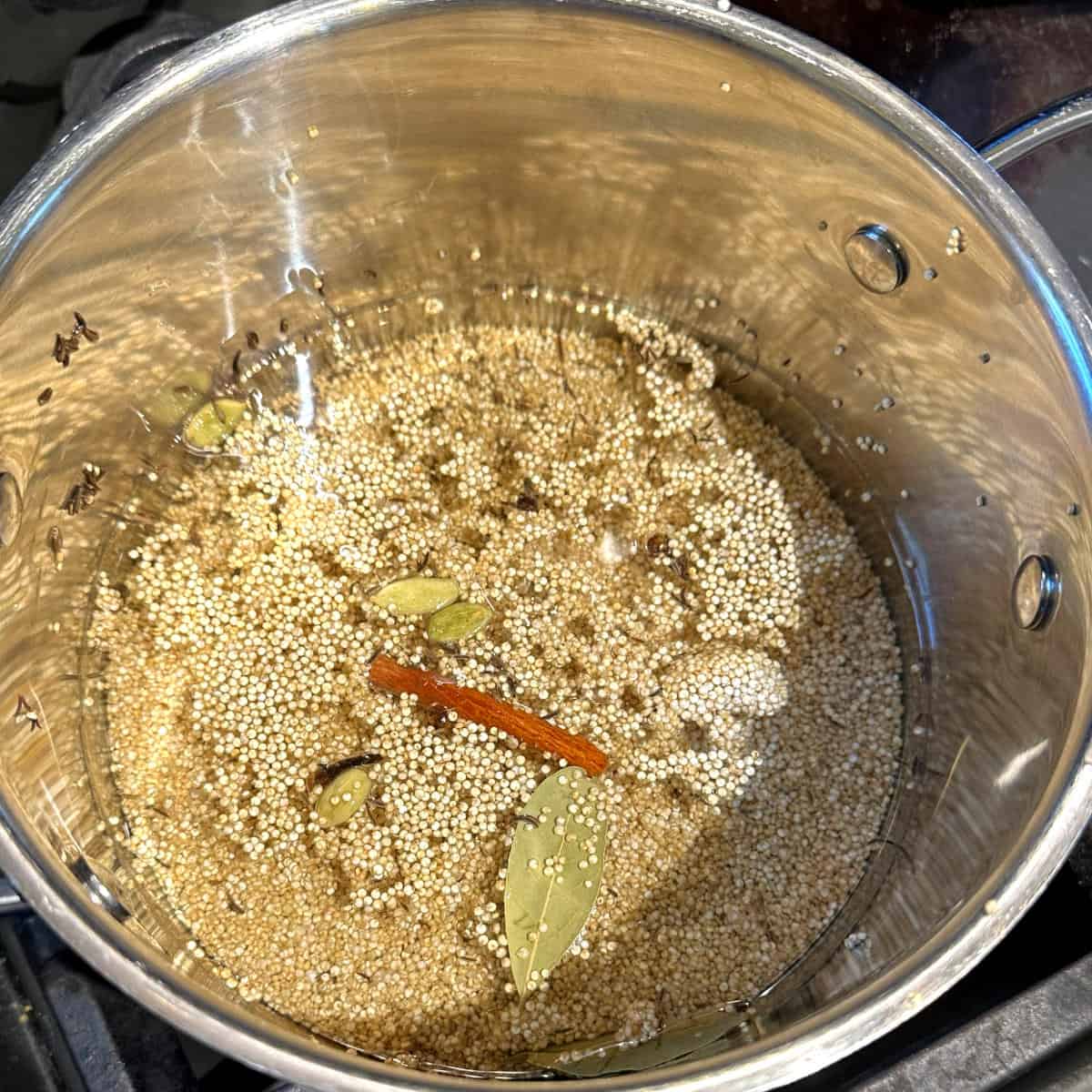 Quinoa added to water with spices.