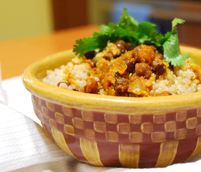 Bowl with quinoa biryani with cilantro garnish.