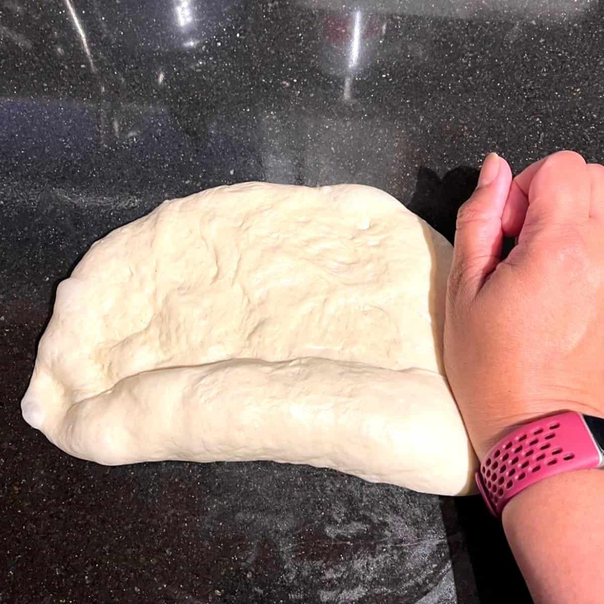 Italian bread loaf being shaped.