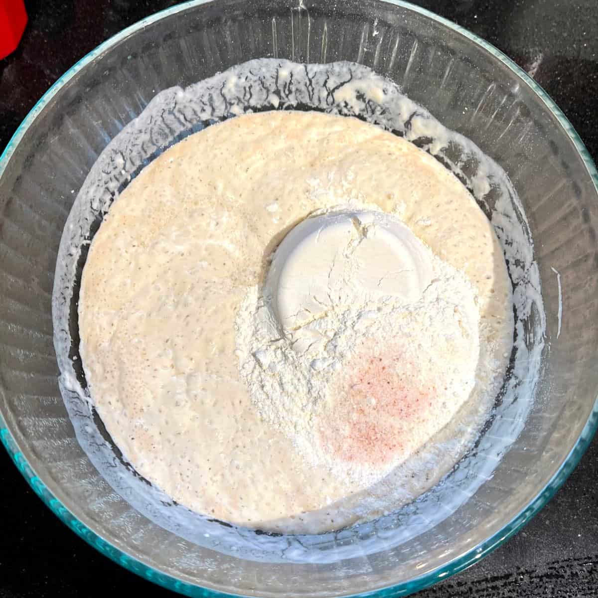 Flour and salt added to biga for Italian bread.