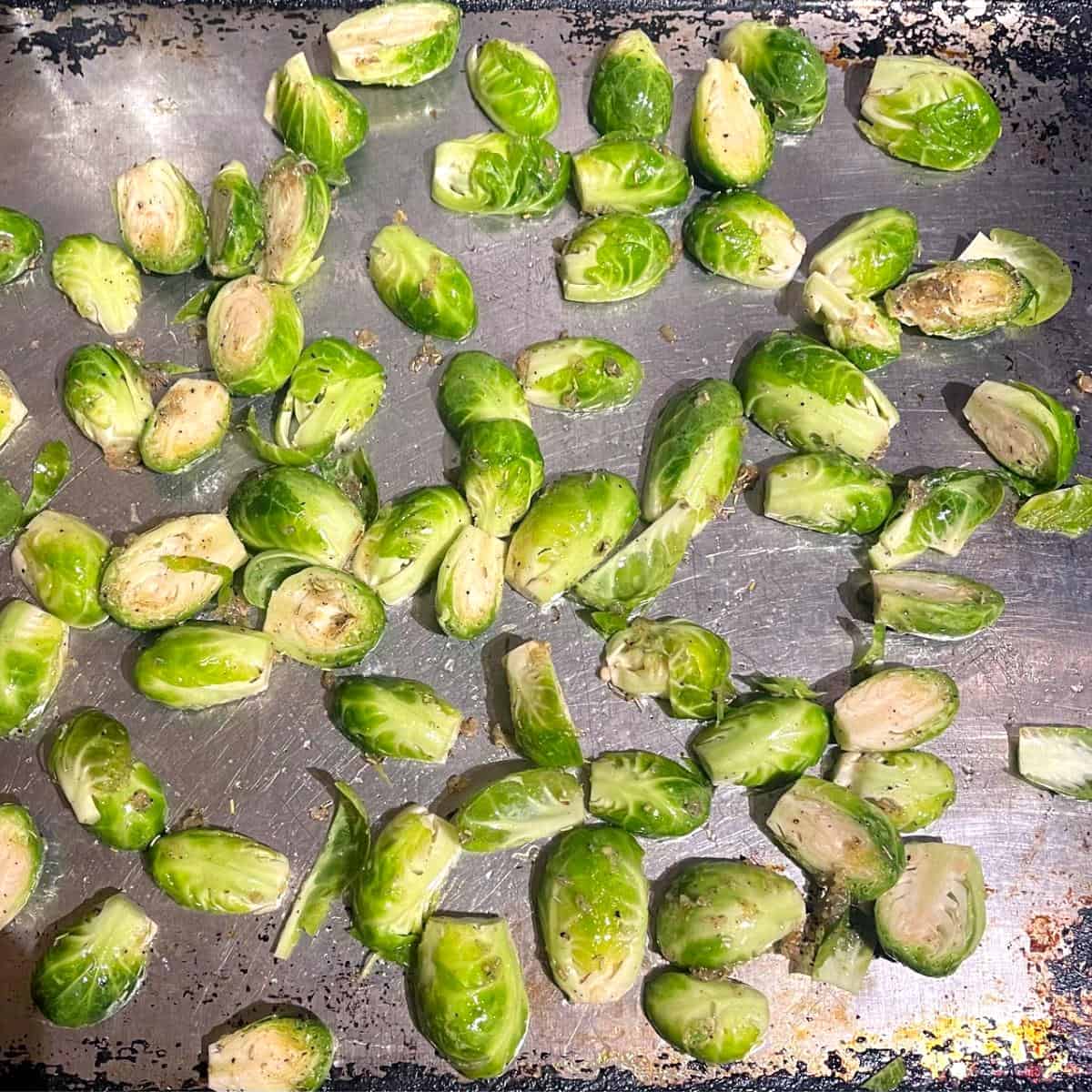 Brussels sprouts on baking sheet before roasting.