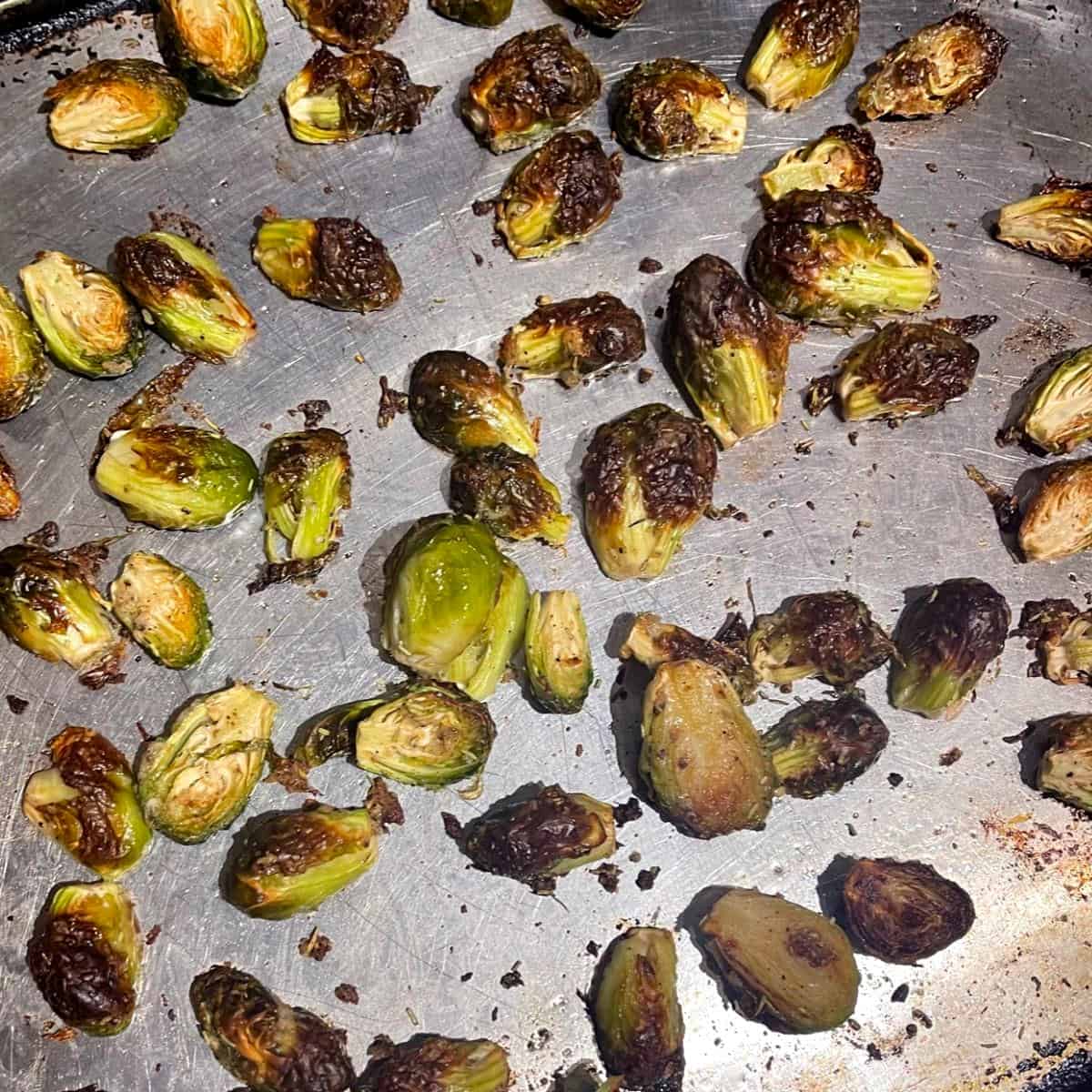 Roasted brussels sprouts on baking sheet.