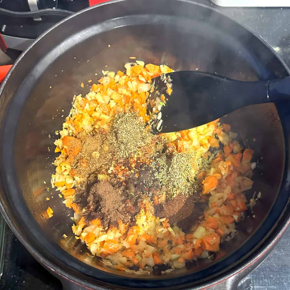 Spices added to crockpot with veggies.