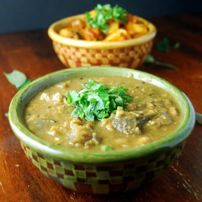 Brinjal Pulippu Kootu in two bowls with cilantro.
