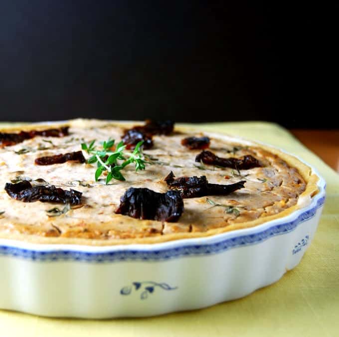 Partial photo of Sundried Tomato Quiche in a blue and white floral ceramic tart baking dish.