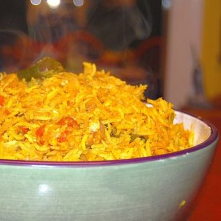 Steaming cabbage rice in green bowl.