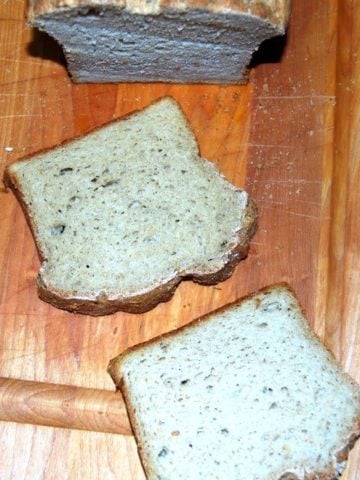 Slices of vegan gluten-free sandwich bread on wooden board.