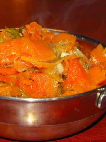Herbed pumpkin in a karahi bowl.