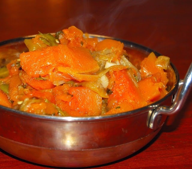 Herbed pumpkin in a karahi bowl.