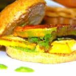 Vegan blt sandwich with green tomato on white plate.