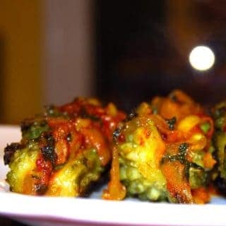 Stuffed bitter melons or karela with masala in white plate.