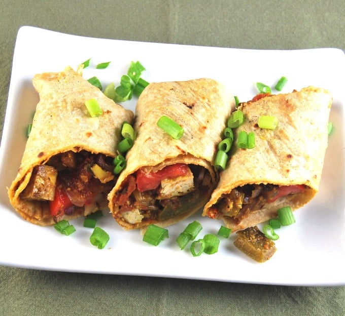 Vegan Kati Rolls on a white plate with tofu filling showing.