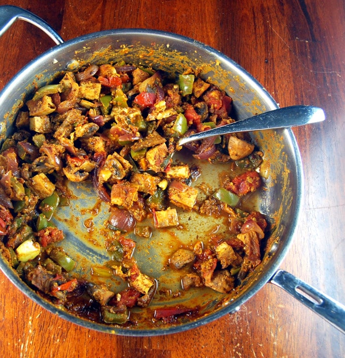 A steel saucepan with tofu filling for vegan kati roll.