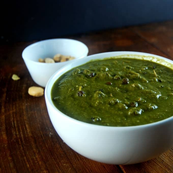 Photo of Chana Makhani in a bowl with cashew nuts behind.